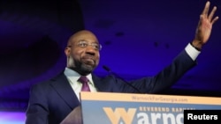 US Senator Raphael Warnock (D-GA) speaks during an election night party in Atlanta, Georgia, Dec. 6, 2022.