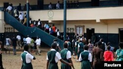 FILE - Liberian children line up to enter classrooms.