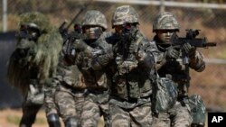 FILE - South Korean marines secure an area during their regular drill on Yeonpyeong Island, South Korea, Nov. 1, 2018. 
