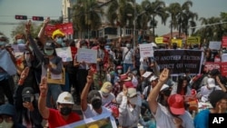 Demonstrators display placards during a protest close to Indonesian Embassy in Yangon, Myanmar, Tuesday, Feb. 23, 2021. Anti-coup protesters gathered outside the embassy following reports that Indonesia was seeking to have fellow members of the…