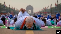 Indian Prime Minister Narendra Modi performs yoga with a crowd of thousands in New Delhi, India, June 21. (AP Photo/Saurabh Das)