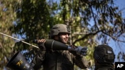 Israeli soldiers load ammunition onto an Armored Personnel Carrier (APC) at a staging ground near the Israel-Gaza border, May 14, 2021. 