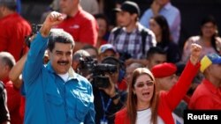 FILE - Venezuela's President Nicolas Maduro and his wife, Cilia Flores, greet supporters at a rally marking the 60th anniversary of the end of dictator Marcos Perez Jimenez's regime, in Caracas, Jan. 23, 2018.