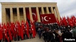 People rush to the entrance of the mausoleum of Mustafa Kemal Ataturk, during a ceremony marking his death anniversary, in Ankara, Turkey, Nov. 10, 2016.