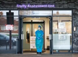 An NHS worker is pictured outside the Aintree University Hospital before the Clap for our Carers campaign in support of the NHS, as the spread of the coronavirus disease (COVID-19) continues, in Liverpool, Britain, April 23, 2020.