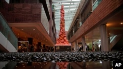 FILE - The "Pillar of Shame" statue, a memorial to those killed in the 1989 Tiananmen crackdown, is displayed at the University of Hong Kong, Oct. 13, 2021. The monument was boarded up by workers late Wednesday. 