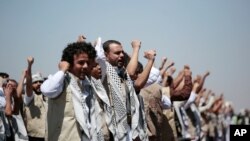 FILE - In this Oct. 16, 2020, file photo, Yemeni prisoners chant slogans during their arrival after being released by the Saudi-led coalition at the airport in Sanaa, Yemen.