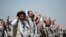 FILE - In this Oct. 16, 2020, file photo, Yemeni prisoners chant slogans during their arrival after being released by the Saudi-led coalition at the airport in Sanaa, Yemen.