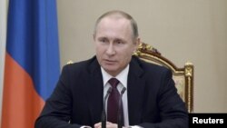 Russian President Vladimir Putin chairs a meeting with members of the Security Council at the Kremlin in Moscow, Russia, Jan. 22, 2016. 