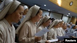 FILE - Catholic nuns attend mass at the Jesuit Apostolic Center in Seoul.