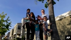 FILE - A young American family shopping for a house.