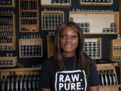 Violet Amoabeng from Skin Gourmet buys shea butter from women in the north. Dec 9, 2020 (Stacey Knott/VOA)