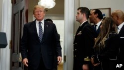 President Donald Trump arrives to an event to honor Dr. Martin Luther King Jr., in the Roosevelt Room of the White House, Friday, Jan. 12, 2018, in Washington. (AP Photo/Evan Vucci)