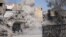 FILE - Smoke rises after a landmine is exploded as fighters of Syrian Democratic Forces clear roads after the liberation of Raqqa, Syria, Oct. 18, 2017. 