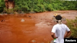 An Indigenous man from the Pataxo Ha-ha-hae tribe looks at Paraopeba river, after a tailings dam owned by Brazilian mining company Vale SA collapsed, in Sao Joaquim de Bicas near Brumadinho, Brazil, Jan. 25, 2019. 