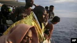 FILE - Migrants wait to reach the Italian coast on the Mediterranean Sea on Sept. 7, 2017, a day after being rescued off the Libyan coast. EU leaders are concerned about a surge of African migrants after Niger repealed an anti-trafficking law following a July 2023 coup.
