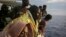 FILE - Migrants wait to reach the Italian coast on the Mediterranean Sea on Sept. 7, 2017, a day after being rescued off the Libyan coast. EU leaders are concerned about a surge of African migrants after Niger repealed an anti-trafficking law following a July 2023 coup.