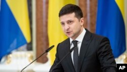 FILE - Ukrainian President Volodymyr Zelenskiy speaks in Kyiv, Dec. 4, 2019.