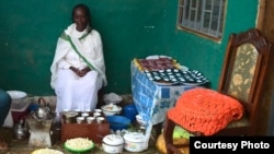 The front porch is the setting for coffee ceremonies where women of Dosha discuss new health practices for the neighborhood (VOA/Joana Mantey)