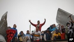 Inmates riot from the roof of the Villa Devoto prison as they protest against authorities who they say are not doing enough to prevent the spread of coronavirus inside the jail in Buenos Aires, Argentina, April 24, 2020. 