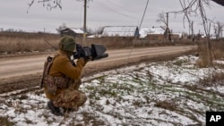 FILE - In this photo provided by the Ukrainian 10th Mountain Assault Brigade "Edelweiss," a Ukrainian soldier holds an anti-drone gun on his position near Bakhmut, Donetsk region, Ukraine, Nov. 23, 2023. Ukraine's military reported shooting down five Russian drones Dec. 18, 2023.