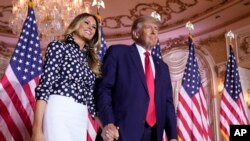 Former President Donald Trump stands on stage with former first lady Melania Trump after he announced a run for president for the third time at Mar-a-Lago in Palm Beach, Fla., Tuesday, Nov. 15, 2022. 