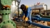 FILE - A worker is seen at the Zarzaitine gas field in In Amenas, 1,600 km (994 miles) southeast of Algiers, Jan. 22, 2013. Algeria closed a land pipeline, Oct. 31, 2021, after a diplomatic dispute with its neighbor Morocco, through which the pipeline passes.