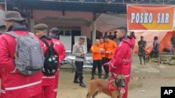 In this photo released by the Indonesian National Search and Rescue Agency, rescuers prepare to head out to the site of a landslide that killed a number of people, in Suwawa on Sulawesi Island, Indonesia, July 8, 2024. 