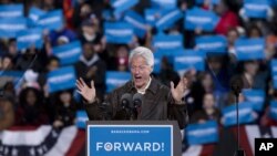 In the final hours of a four-state campaign day, President Barack Obama is introduced by former President Bill Clinton at a rally at Jiffy Lube Live arena, November 3, 2012, in Bristow, Virginia.