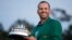Spain's Sergio Garcia holds the first-place trophy while wearing the winner's green jacket after taking after Masters' title in a playoff, April 9, 2017, in Augusta, Georgia.