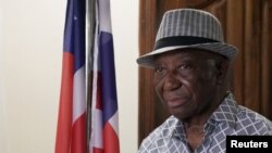 Opposition Unity Party and Liberia president-elect Joseph Boakai looks on next to a Liberian flag, at his home in Monrovia, Nov. 19, 2023. 
