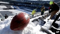 A football with the Super Bowl XLVIII logo after a recent snow at MetLife Stadium in East Rutherford, New Jersey.