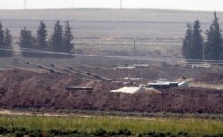 Turkish forces artillery pieces are seen on their new positions near the border with Syria in Sanliurfa province, Oct. 6, 2019.