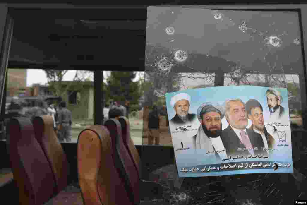 An election poster of Afghan presidential candidate Abdullah Abdullah is pictured on the broken window of a bus damaged during a bomb attack in Kabul, June 6, 2014.