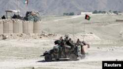 FILE - Afghan special forces patrol in Pandola village near the site of a U.S. bombing in the Achin district of Nangarhar province in eastern Afghanistan, April 14, 2017.