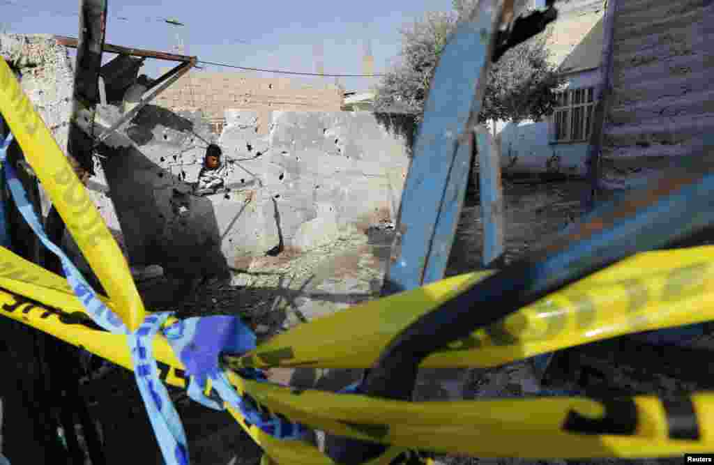 A man looks at the damaged house where five Turkish civilians were killed by a mortar bomb in the southern border town of Akcakale, Turkey October 4, 2012.