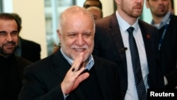 Iranian Oil Minister Bijan Zanganeh wave to journalists as he arrives for a meeting of OPEC oil ministers at OPEC's headquarters in Vienna, Austria, Dec. 4, 2013. 