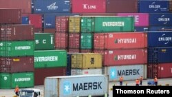 Truck transports a container at a port in Qingdao, Shandong