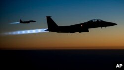 FILE - A pair of U.S. F-15E Strike Eagle flies over northern Iraq, after conducting airstrikes in Syria. 