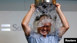FILE - SoftBank Corp. Chief Executive Masayoshi Son dumps a bucket of ice water onto himself as he takes part in the ALS ice bucket challenge at the company headquarters in Tokyo August 20, 2014.