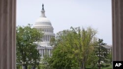 FILE - Capitol building is seen through the columns on the steps of the Supreme Court in Washington.