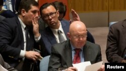 Russian diplomats gesture behind Russian Ambassador to the United Nations Vassily Nebenzia during a Security Council meeting at the U.N. headquarters in New York, Sept. 4, 2017.