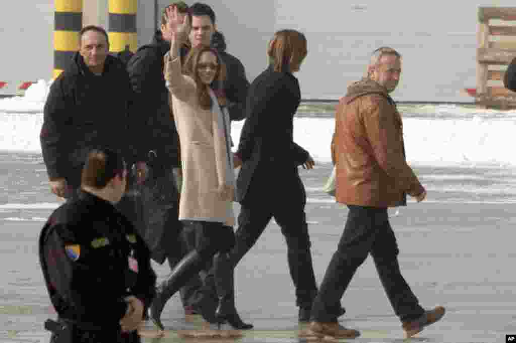 Angelina Jolie waves to reporters as she arrives at the Sarajevo International Airport in Sarajevo, Bosnia on February 14, 2012, for the screening of her film 'In the Land of Blood and Honey'. (AP)