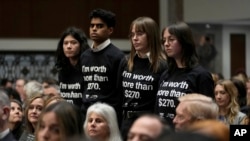 Protesters stand up during a Senate Judiciary Committee hearing with social medial platform heads on Capitol Hill in Washington, Jan. 31, 2024, to discuss child safety.