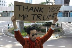 A man holds a placard during a lunchtime protest in Hong Kong, Nov. 28, 2019.