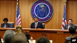 Federal Communications Commission Chairman Ajit Pai, center, announces the vote to repeal net neutrality, next to Commissioner Mignon Clyburn, left, who voted no, and Commissioner Michael O'Rielly, who voted yes, at the FCC, Dec. 14, 2017.