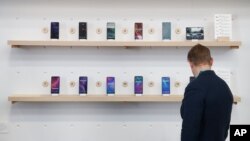 FILE - The Google exhibit building shows off a variety of devices with Google Assistant, including Android smartphones and Wear OS smartwatches during the CES tech show in Las Vegas, Jan. 8, 2020.