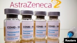 FILE - Vials with a sticker reading, "COVID-19" are seen in front of a displayed AstraZeneca logo in this illustration taken October 31, 2020. (REUTERS/Dado Ruvic/Illustration/File Photo)