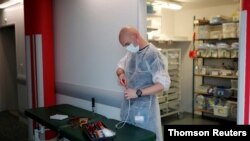 French hospital electrician Benjamin Le Bris repairs a medical bed in the Intensive Care Unit at the hospital in Vannes during the outbreak of the coronavirus disease in France, May 6, 2020.