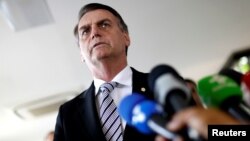 Brazil's President-elect Jair Bolsonaro talks to the media, in Brasilia, Brazil, Nov. 7, 2018. 